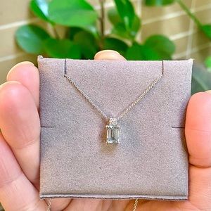 White gold diamond pendant necklace with emerald cut aquamarine